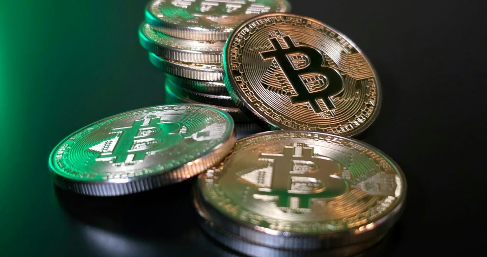 a pile of bitcoins sitting on top of a table