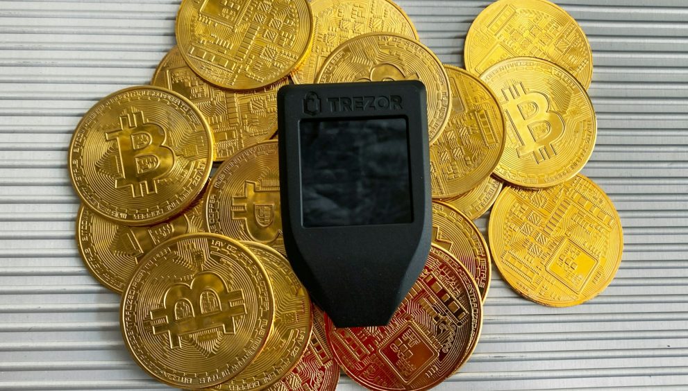 a cell phone sitting on top of a pile of gold coins